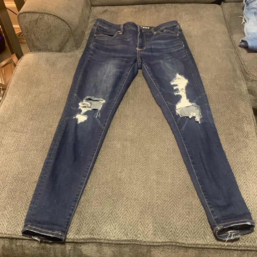 Dark wash American Eagle jeans. With some distress.